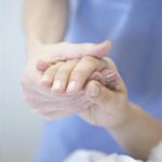 Nurse Holding Patient's Hand